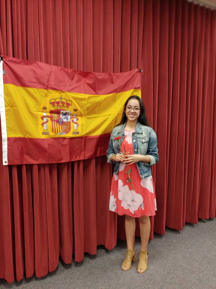 Estefania Montoya posing in front of Spanish flag